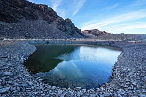 Stillness Prints: Clear mountain reflections in a high alpine tarn near Cerro del Caballo in Sierra Nevada National Park