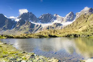 Clear sky over the rocky peaks of Bernina Group and Forbici lake in summer, Valmalenco