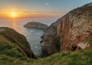 Lighthouses Prints: Cliffs and South Stack Lighthouse at sunset
