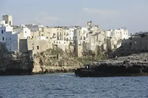 Clifftop houses, built onto rocks, surround the natural cove forming the harbour