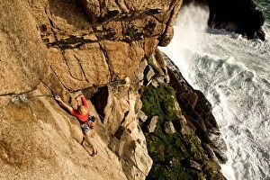A climber on the clas s ic extreme route Raven Wall on the cliffs at Bos igran, near s t