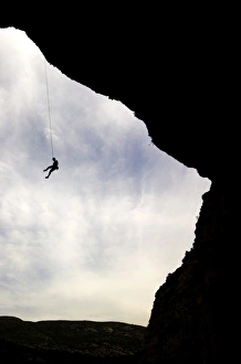 Images Dated 7th September 2008: A climber is lowered from a the edge of a huge cave in the Mascun Gorge