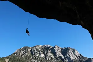 Hanging Prints: A climber lowers off a very overhanging cave climb on the cliffs above Bielsa