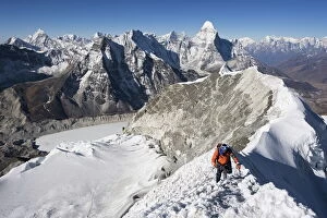 One Man Only Collection: Climber on summit ridge of Island Peak, 6189m, Ama Dablam, 6812m, Solu Khumbu Everest Region