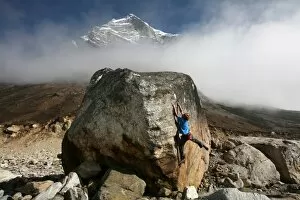 A climber tackles a difficult boulder problem on the glacial moraine at Tangnag