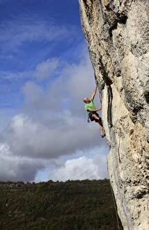 Images Dated 25th October 2009: A climber tackles a steep and challenging route on the cliffs of the Aveyron Gorge