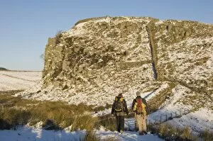 Two climbers head for the crags at Steel Rigg, Hadrians Wall, UNESCO World Heritage Site