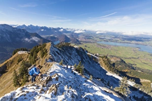 Climbers on steep crest covered with snow in the Ammergau Alps, Tegelberg, Fussen