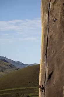 Two climbers tackle a difficult route on a huge buttress on the Tsaranoro Massif