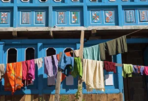 Close up of colourful laundry hanging in front of blue