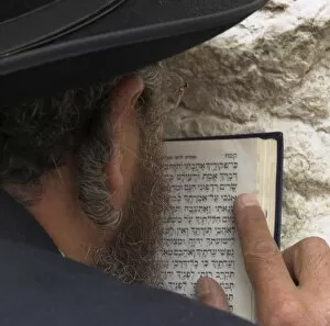 Close up of an Orthodox Jew holding prayer book against