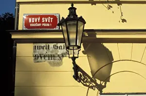 Lamp Prints: Close-up of current and historical street signs with lamp on a wall, Hradcany