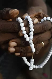 Search Results: Close-up of hands of African Muslim man praying with Islamic prayer beads (tasbih), Togo