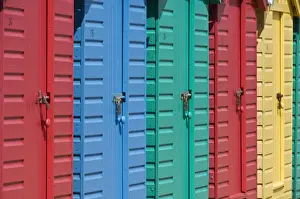 Multi Coloured Prints: Close-up of multicoloured beach huts on the long sweeping beach of Llanbedrog