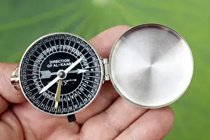 One Man Only Prints: Close-up of a Muslim using a Qibla compass to indicate the direction of Al Kaaba