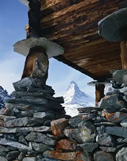Stilt Prints: Close-up of rocks and wooden building of an old raccard at Findeln