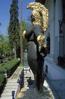 Otto Wagner Prints: Close-up, side view of a female nude statuewith gold headdress in front of the building