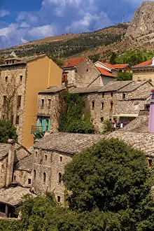 Cobblestone Prints: Close-up view of stone buildings and slate roofs in Old Town Mostar with colorful accents