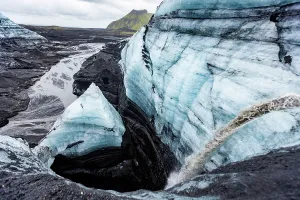 Glacial Prints: Close view of glacier surface showing volcanic sediment and meltwater channels in Icelandic ice near Vik