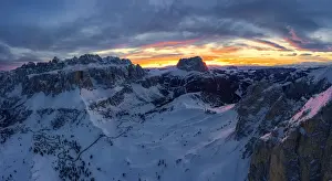 Sassolungo Prints: Clouds in the burning sky at sunset over Sassolungo and Sella Group mountains covered