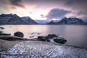 Nordland Gallery: Clouds at dawn over the cold sea and Vareid beach covered with snow, Flakstad, Nordland county