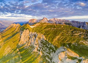 Clouds at dawn over the majestic Santis and Saxer Lucke mountains, aerial view