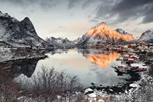 Olstind Prints: Clouds at dawn over traditional Rorbu and Olstind mountain reflected in sea, Reine Bay