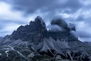 South Tyrol Prints: Clouds at dusk in the foggy sky over Tre Cime di Lavaredo mountain peaks