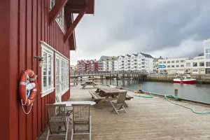Svolvaer Prints: Clouds frame the typical wooden houses of the fishing village surrounded by sea, Svolvaer