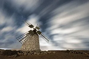 Windmills Prints: Clouds in the starry sky over a traditional windmill, La Oliva, Fuerteventura