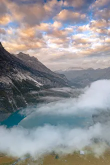 Kandersteg Prints: Clouds at sunset over the pristine lake Oeschinensee in the mist, Bernese Oberland