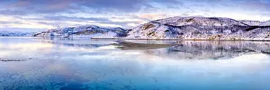 Arctic Gallery: Clouds at sunset on snow capped mountains reflected in the clear water of Laksefjorden