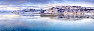 Fjord Prints: Clouds at sunset on snow capped mountains reflected in the clear water of Laksefjorden