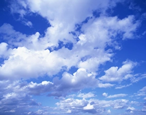 Cloudscape of puffy white clouds in a blue sky