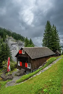 Chalet Prints: Cloudy day at Tschinglengorge with traditional house and surrounding nature in Switzerland