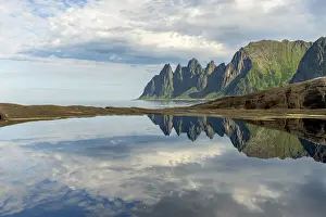 Tungeneset Prints: Cloudy sky over majestic rocks of mountain peaks mirrored in water, Tungeneset, Senja