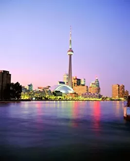 The CN tower rises above the city skyline at dusk, Toronto, Ontario, Canada