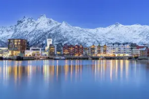 Light Beam Prints: Coastal town of Svolvaer framed by snowcapped mountains at dusk