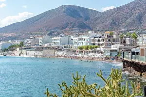 Limenas Prints: Coastline view with beach activities and buildings along Paralia Limena Chersonisou in Crete