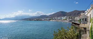 Promenade Prints: Coastline view of Paralia Limena Chersonisou Beach with clear waters and mountains in the background
