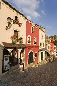 Cobbled street lined with colourful houses known as Kujundziluk, one of the oldest streets in Mostar leading to the Old Bridge, Old Town, UNESCO World Heritage Site, Mostar, Herzegovina, Bosnia