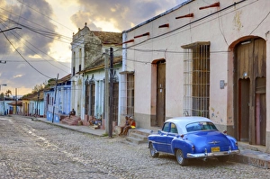 Images Dated 30th March 2009: Cobbled street at sunset with classic American car, Trinidad, Cuba, West Indies