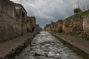 Preserved Prints: A cobblestone street running through the centre of the Roman ruins of Pompeii