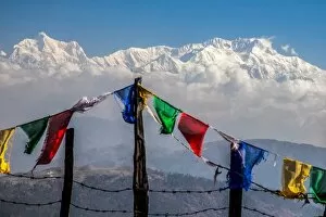 Images Dated 22nd April 2010: Colored prayer flags flutter in front of the majestic Kanchenjunga, the third highest
