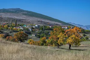 Rustic Prints: Colorful autumn trees overlook a quiet village in Dagestan