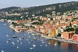 Residence Prints: Colorful buildings line the coastline with boats in Villefranche-sur-Mer harbor in southeastern France