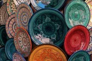 Artistry Prints: Colorful ceramic plates displayed in the souk of Marrakech showcasing local craftsmanship and artistry in Morocco