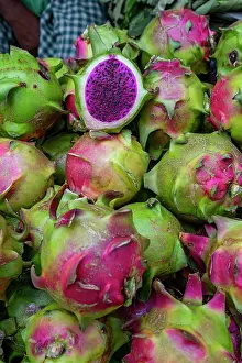 Fresh Prints: Colorful dragon fruits at a bustling vegetable market in Dhaka