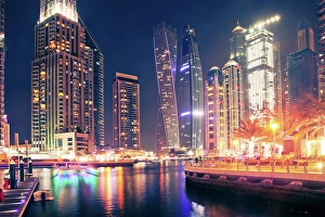 Glittering Prints: Colorful evening on canal and promenade in Dubai Marina, Dubai, United Arab Emirates