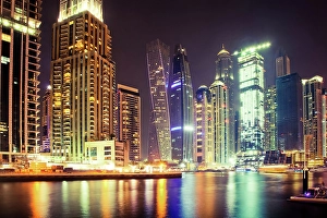 Cosmopolitan Prints: Colorful evening on canal and promenade in Dubai Marina, Dubai, United Arab Emirates